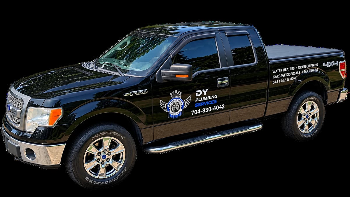 DY Plumbing Services black Ford F-150 service truck with company branding and phone number on the door